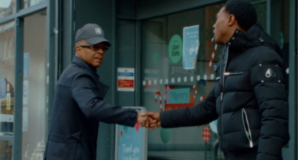 Harrow Road Soup Kitchen founder Deujean Bernard shaking hands with a local person from the community